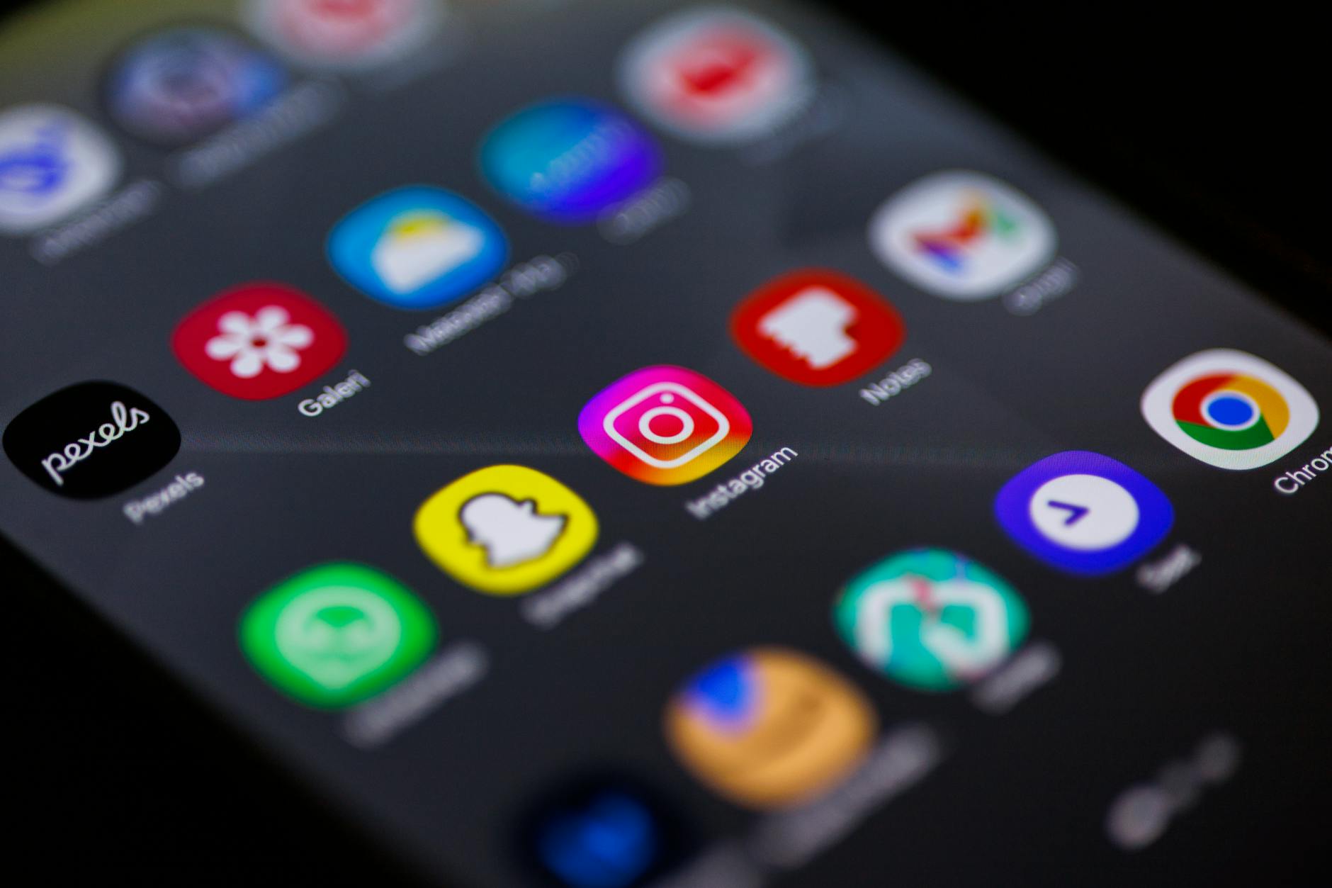 close up of mobile phone home screen with apps